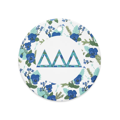 Delta Delta Delta Holiday ornament shown in full view featuring filled Tri Delt letters and pansy floral print accent