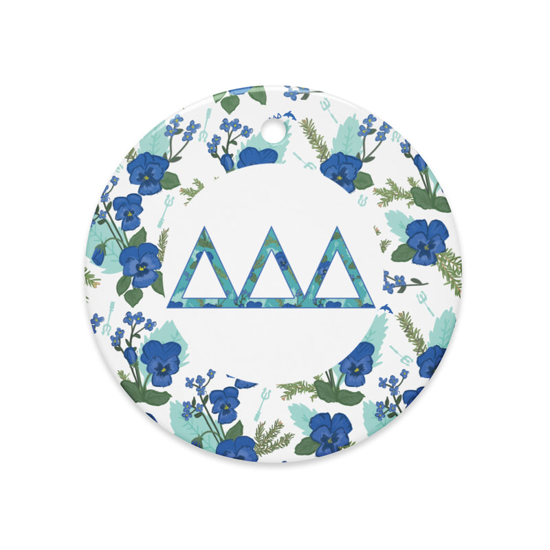 Delta Delta Delta Holiday ornament shown in full view featuring filled Tri Delt letters and pansy floral print accent