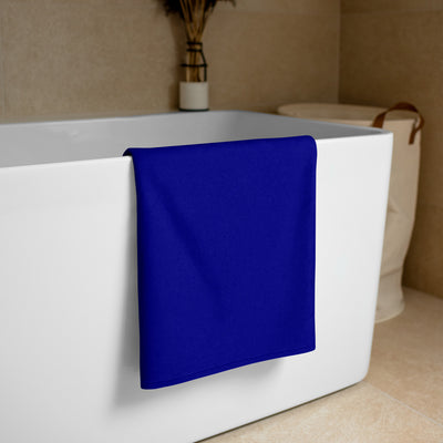 delta gamma navy and white towel draped over bathtub