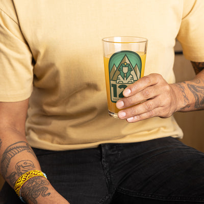 Delta Sigma Phi 125th Anniversary Pint Glass in man's hand