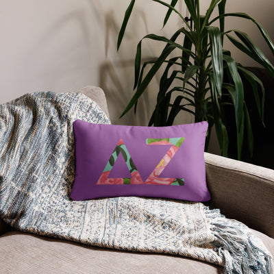 Delta Zeta Sorority Pillow with DZ letters filled with pink rose floral print shown on couch in 20" x 12" size