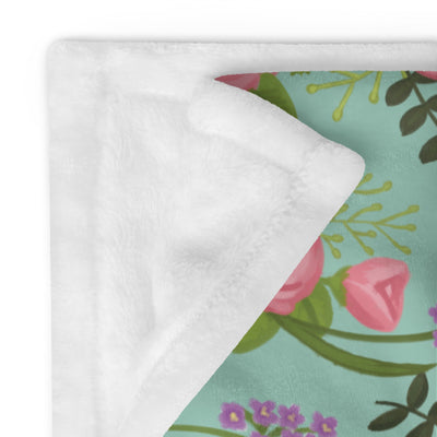 Delta Zeta Sorority Throw Blanket in green floral print showing solid white reverse side