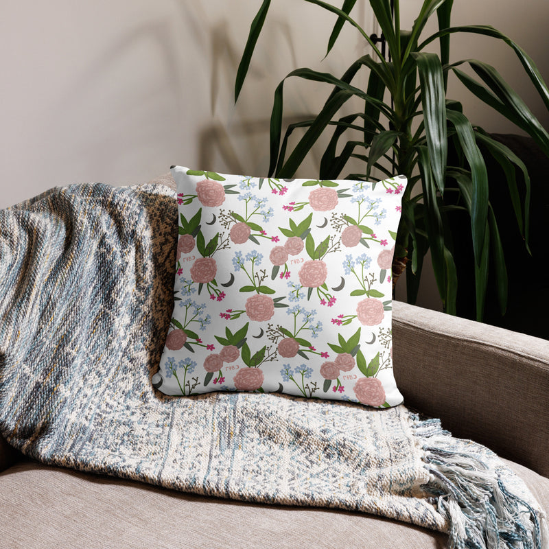 Gamma Phi Beta 1874 Reversible Pillow showing carnation floral print in white shown on couch