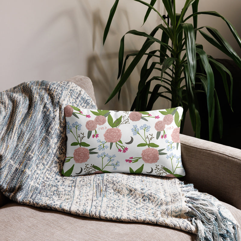 Gamma Phi Beta Sorority Motto Pillow showing floral print on reverse side shown on couch