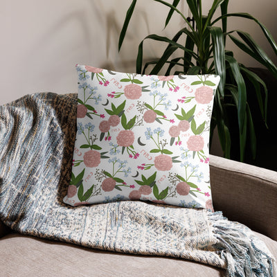 Gamma Phi Beta Filled Letters Pillow showing floral print on back in white on 22" x 22" size shown on couch