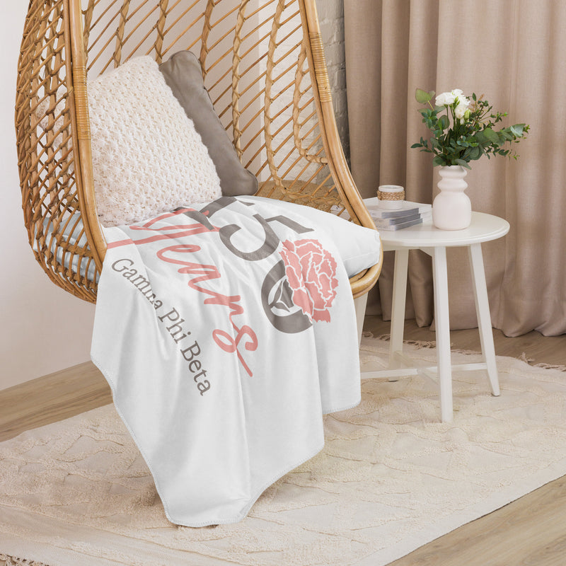 Gamma Phi Beta 150th Anniversary Blanket shown in lifestyle setting