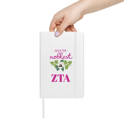 Zeta Seek the Noblest Hardcover Journal in white in woman's hand