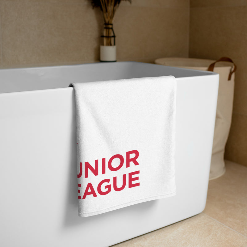 Junior League Beach and Bath Towel in white shown folded over bathtub