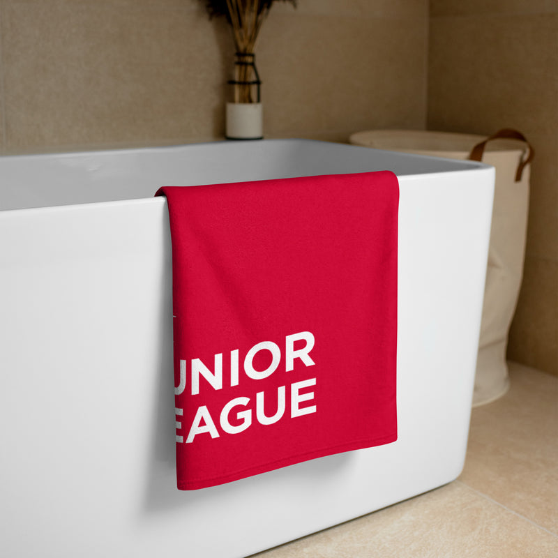 Junior League Red and White Beach Towel shown folded over a bathtub