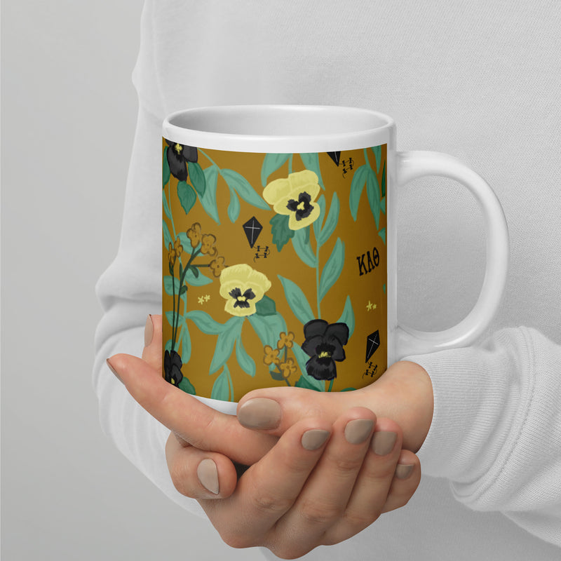 Kappa Alpha Theta Floral Sorority Mug with Theta letters in 20 oz size in hands
