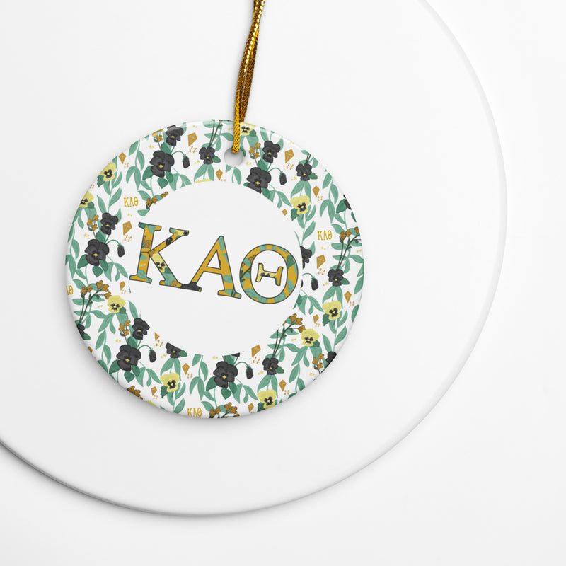 Kappa Alpha Theta Holiday ornament made from ceramic featuring filled Theta letters and pansy floral accent