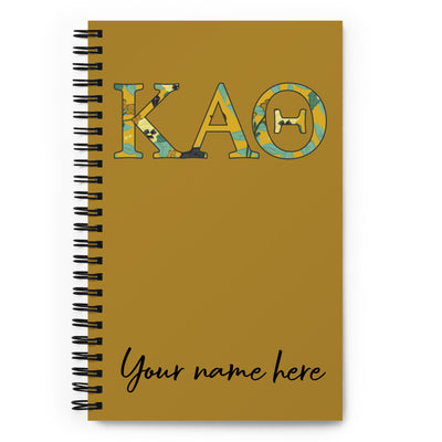 Kappa Alpha Theta notebook with 'KAO' design and space for personalization on a gold notebook