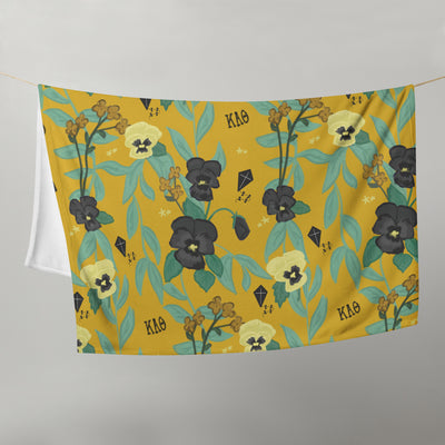 Kappa Alpha Theta Pansy Floral Print Sorority Blanket shown in gold on clothesline