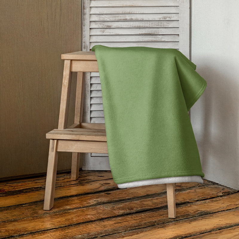Kappa Delta Rose Beach and Bath Towel shown folded over wooden stool