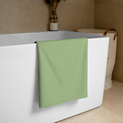 Kappa Delta Rose Beach and Bath Towel shown folded over white bathtub