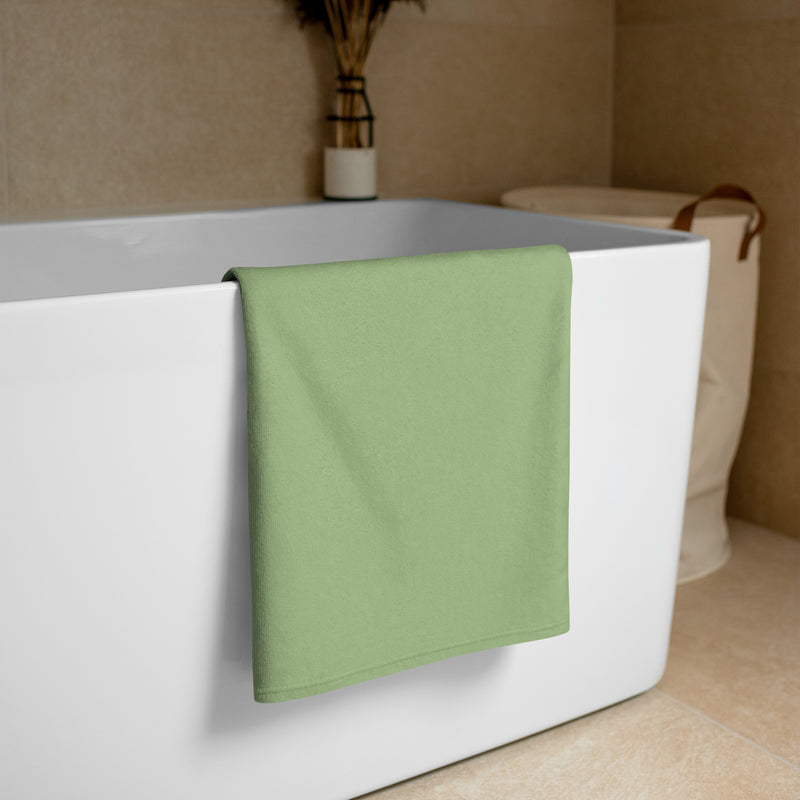 Kappa Delta Rose Beach and Bath Towel shown folded over white bathtub