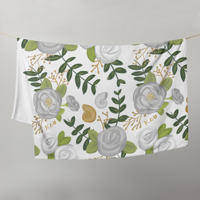 Kappa Delta Floral print throw blanket shown hanging on a clothesline
