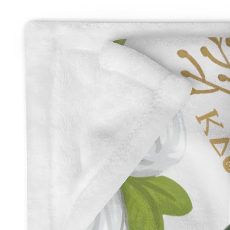 Kappa Delta throw blanket with rose floral print shown folded with white reverse side