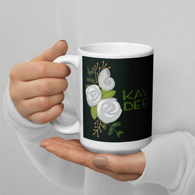 Kay Dee 15 oz rose and nautilus dark green mug shown in woman's hands