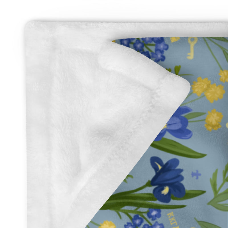 Kappa Kappa Gamma Sorority Throw Blanket shown folded with white reverse side
