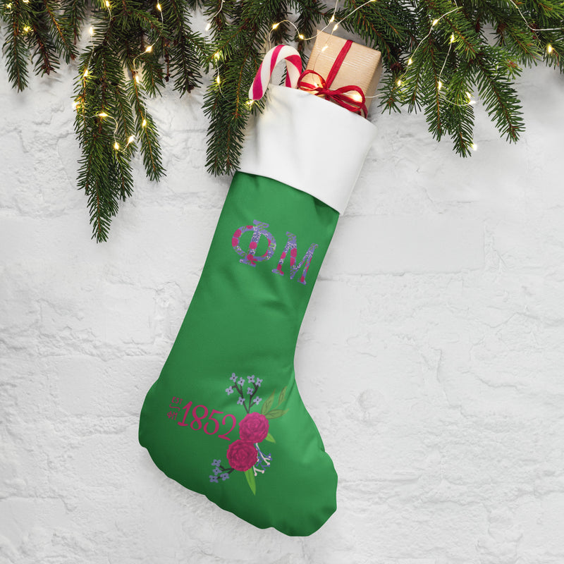 Phi Mu 1852 Holiday Stocking with pine branches and lights