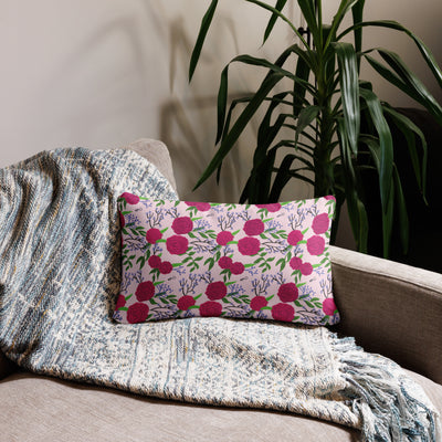 Phi Mu 1852 Reversible Pillow featuring rose-colored carnation floral print on back of 20" x 12" lumbar pillow size on couch