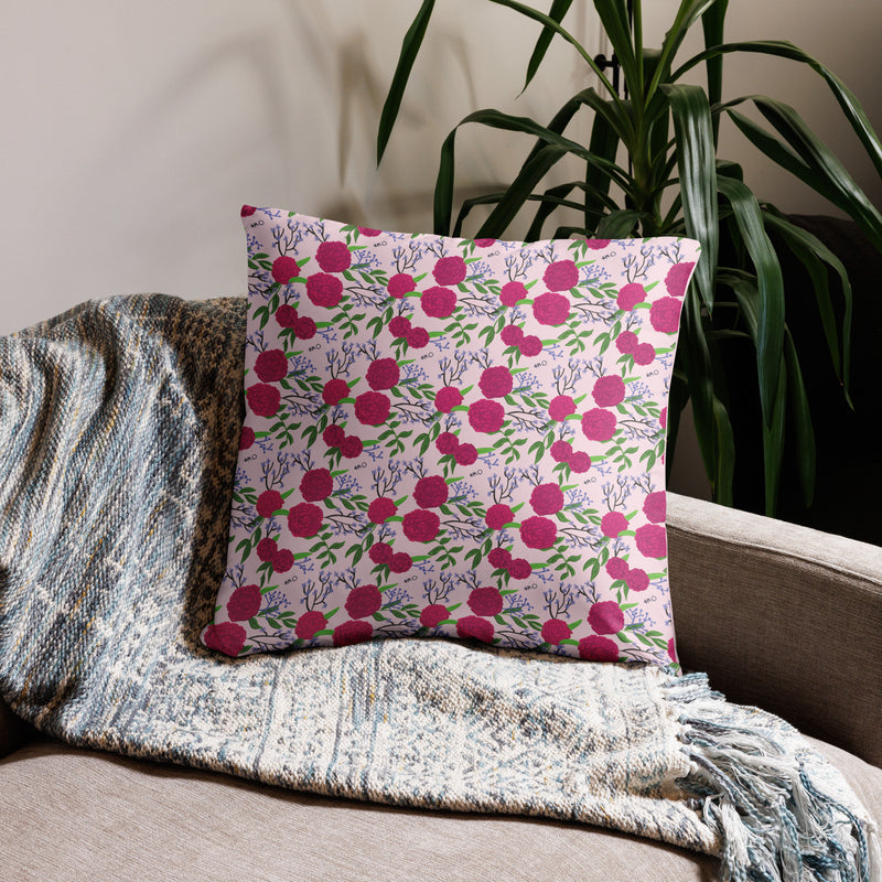 Phi Mu 1852 Reversible Pillow featuring rose-colored carnation floral print on back of 22" x 22" pillow size on couch