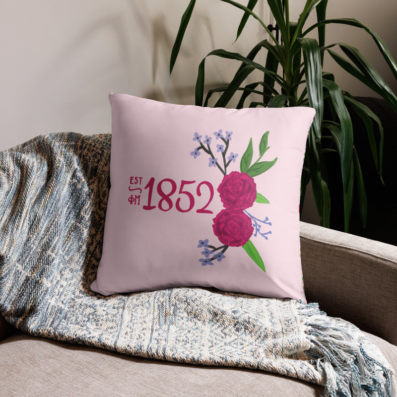 Phi Mu 1852 Reversible Pillow featuring hand drawn 1852 design in pink shown in 22" x 22" pillow size on couch
