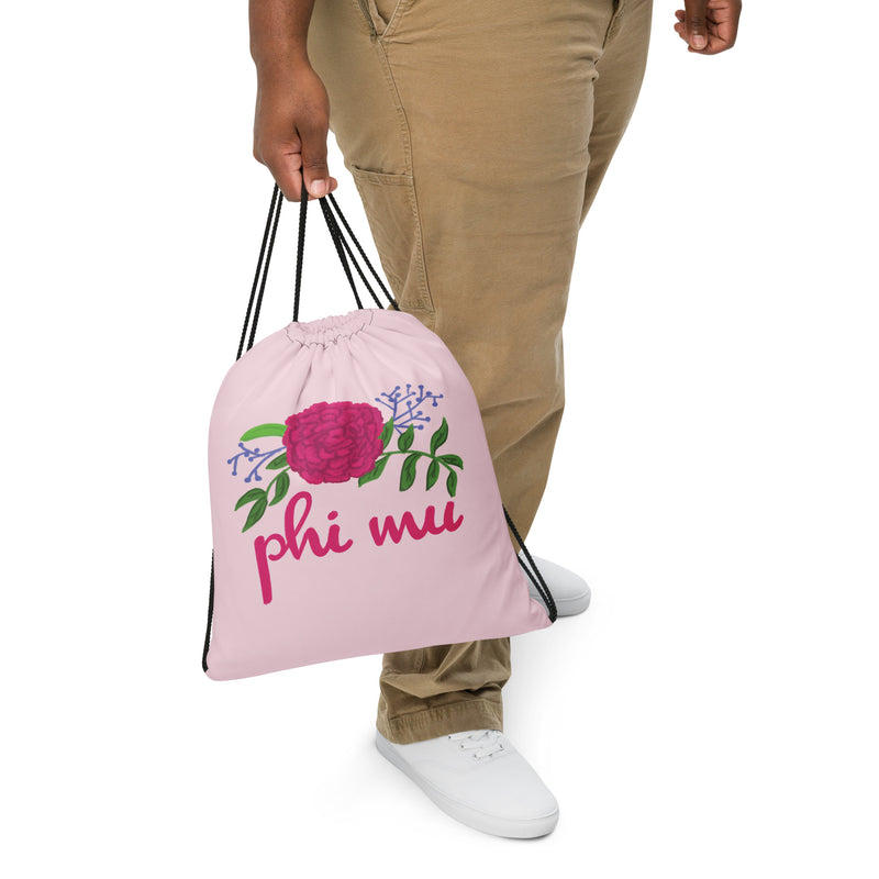 phi mu drawstring bag in pink shown in close up view in model&