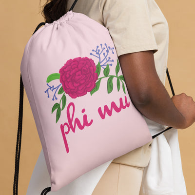 Phi Mu carnation drawstring bag shown on model's shoulder