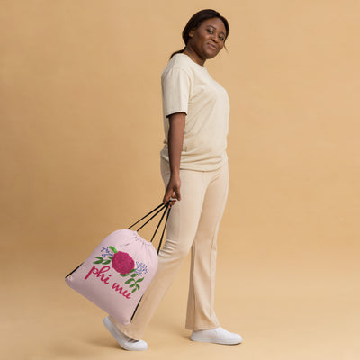 Phi Mu drawstring bag shown in model's hands as she's walking