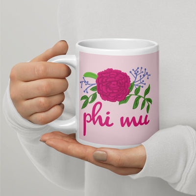 Phi Mu Rose Carnation Sorority Mug shown in 20 oz size in model's hands