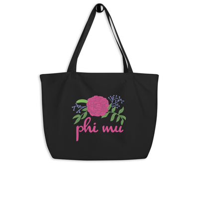 Phi Mu Carnation Tote Bag shown in black hanging on a hook