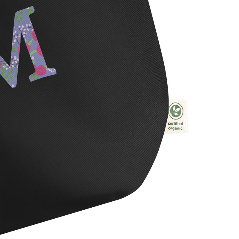Phi Mu Filled Letters Tote Bag in black shown in close up showing certified organic label