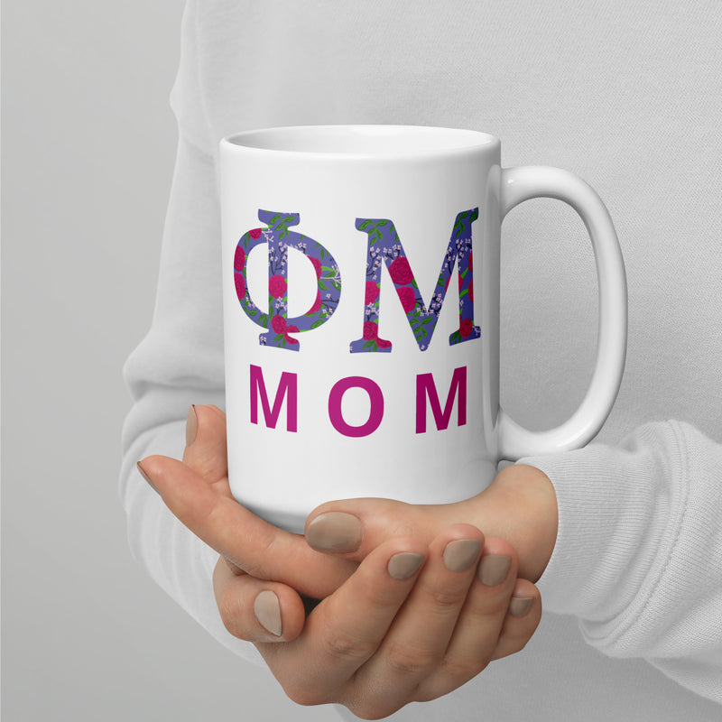 Phi Mu Mom Mug in 15 oz size showing filled letter design in model&