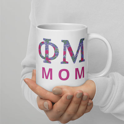 Phi Mu Mom Mug in 20 oz size showing filled letter design in model's hands