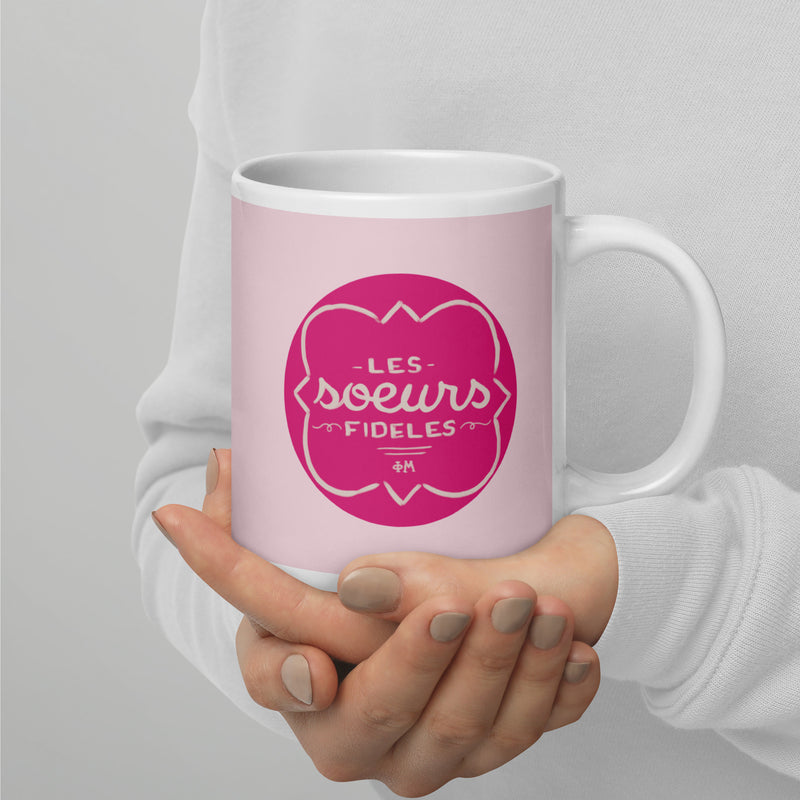 Phi Mu Motto Mug in 20 oz size shown in model&