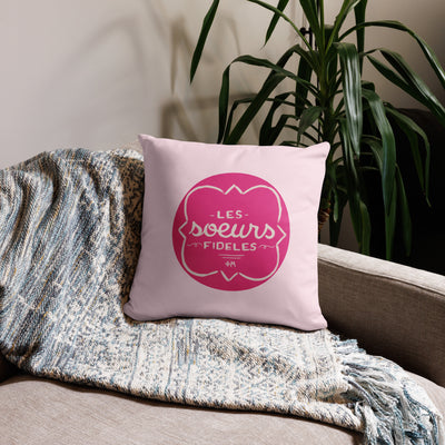 Phi Mu motto reversible pillow in light pink shown on couch