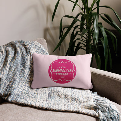 Phi Mu motto reversible pillow showing motto design on front of 20" x 12" lumbar pillow in light pink shown on couch