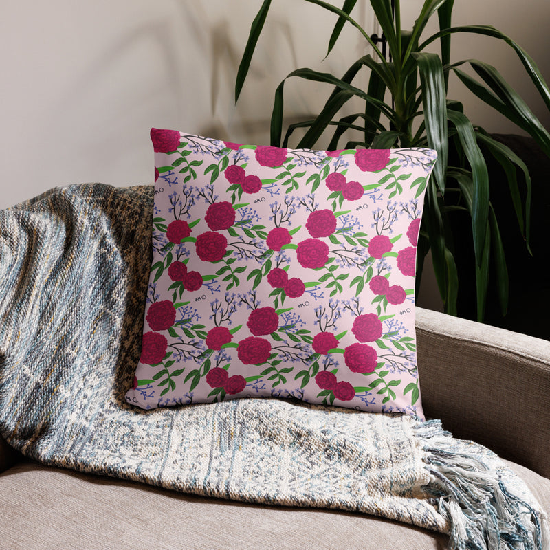 Phi Mu motto reversible pillow showing carnation floral print on back of 22" x 22" pillow in light pink shown on couch