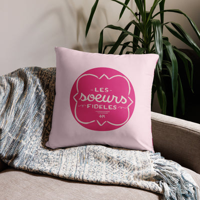 Phi Mu motto reversible pillow showing motto print on front of 22" x 22" pillow in light pink shown on couch