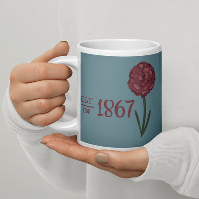 Pi Beta Phi 1867 Mug in 20 oz size in silvery blue shown in model's hands