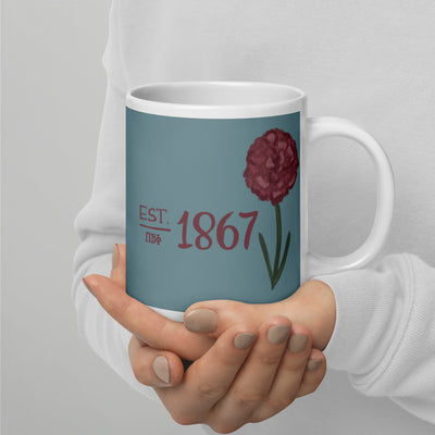 Pi Beta Phi 1867 Mug in 20 oz size shown in model's hands in silver blue