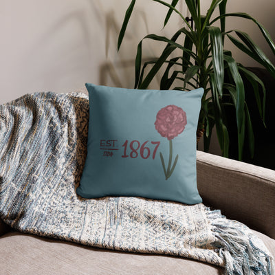 Pi Beta Phi 1867 pillow with two designs in silvery blue and wine shown on couch