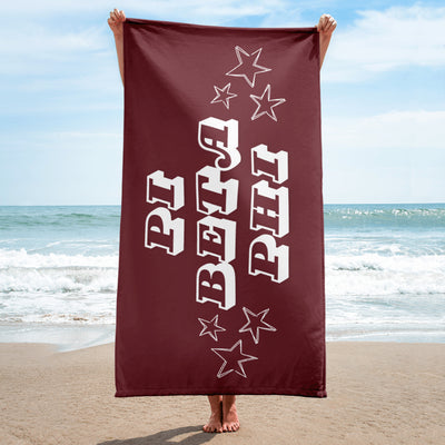Pi Beta Phi Starry Beach Towel in wine shown with model in beach scene