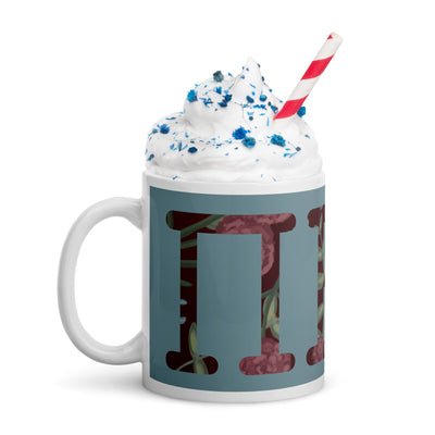 Pi Beta Phi filled letters mug in silvery blue with wine letters filled with floral print in 11 oz size with whipped cream and straw
