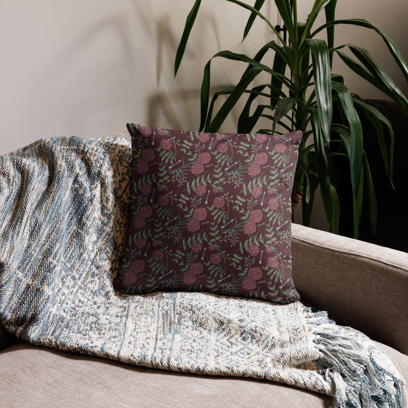 Pi Beta Phi 1867 pillow showing reverse side with carnation floral print in wine on back shown on couch