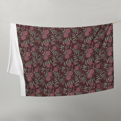 Pi Bets Phi floral print throw blanket in wine color shown hanging on a clothesline