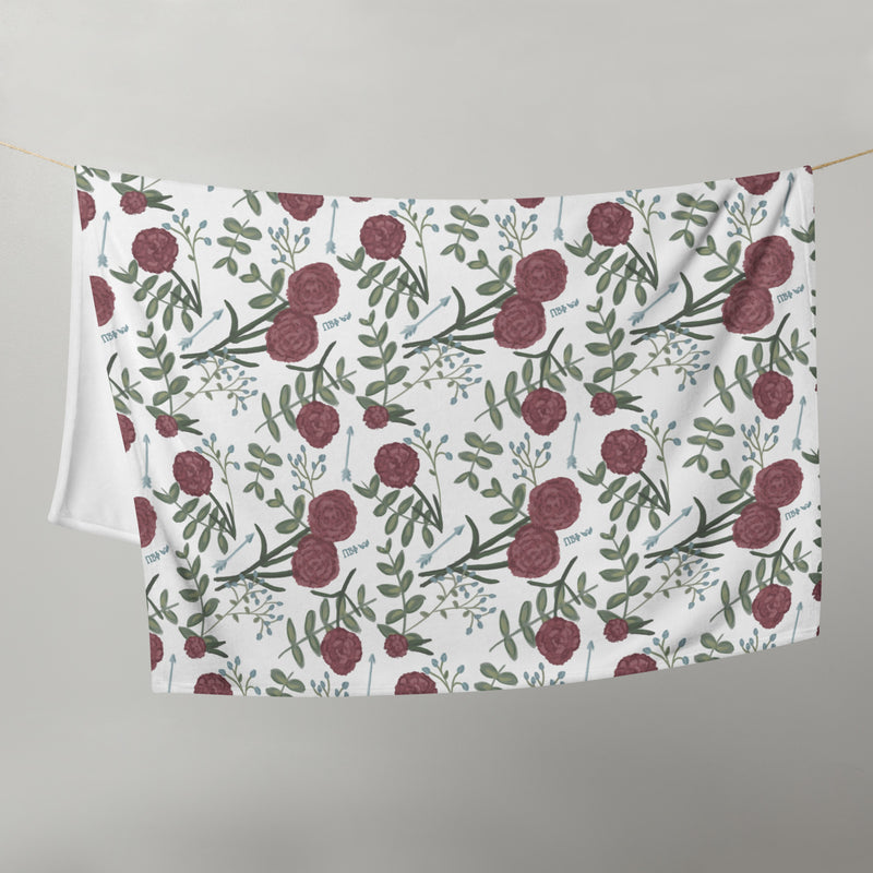 Pi Beta Phi floral throw blanket in white in 50" x 60" size shown hanging on clothesline