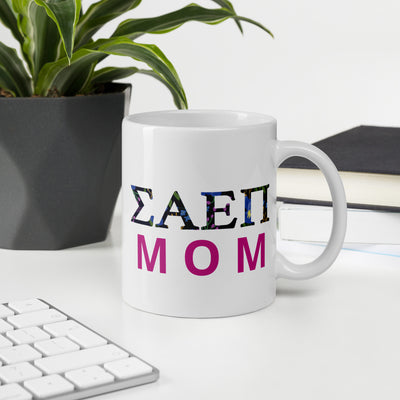 SAEPi Mom Mug showing filled letter design on front of 11 oz mug in office setting